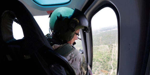 Texas Department of Public Safety Capt. Stacy Holland flies a helicopter to patrol along the Rio Grande, Thursday, July 24, 2