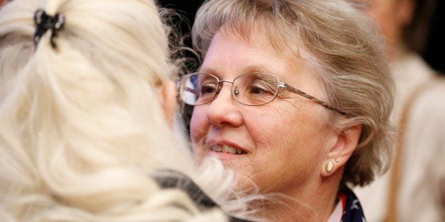 Arizona Republican candidate for State Superintendent Diane Douglas, right, talks with a supporter at the Republican election night party Tuesday, Nov. 4, 2014, in Phoenix. (AP Photo/Ross D. Franklin)