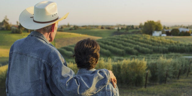Hispanic farmers standing in vineyard
