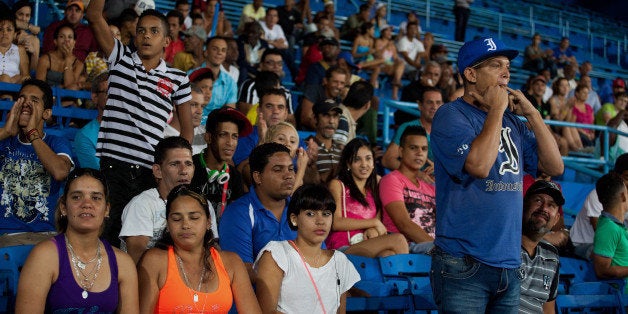 Fans cheer during an Industriales baseball game at El Latinoamericano stadium in Havana, Cuba, on Wednesday, Jan. 21, 2015. Cuba had 19 players on Major League Baseball rosters when last season began, and is one of the most sought-after markets for scouts. Photographer: Lisette Poole/Bloomberg via Getty Images