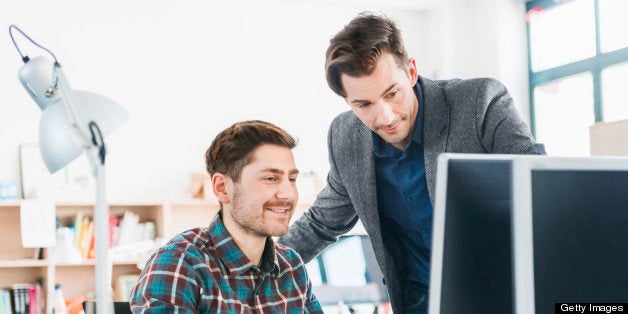 Two young people working together at a startup or small business.