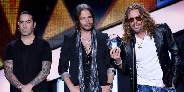 Mana receives the Billboard Spirit of Hope Award at the Latin Billboard Awards in Coral Gables, Fla., Thursday April 25, 2013. (AP Photo/Alan Diaz)