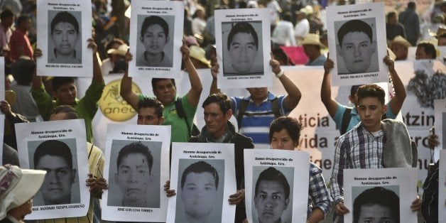 Relatives of 43 missing students hold portraits during a protest demanding justice and clarification of the disappearance of