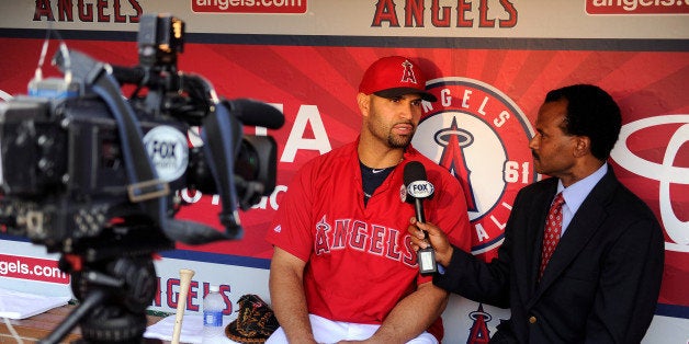 ANAHEIM, CA - JUNE 7: Albert Pujols #5 of the Los Angeles Angels of Anaheim speaks to media member Jose Mota before the game against the Chicago White Sox on June 7, 2014 at Angel Stadium of Anaheim in Anaheim, California. (Photo by Matt Brown/Angels Baseball LP/Getty Images)