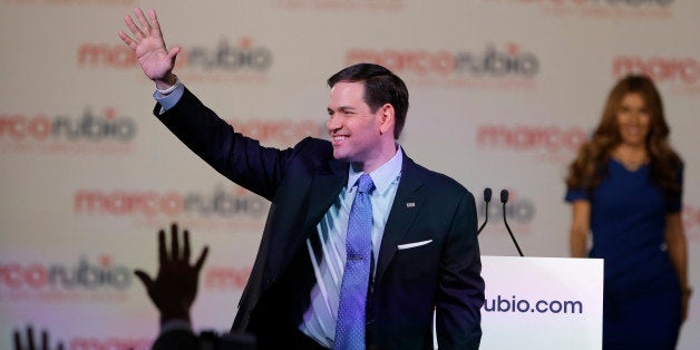 Florida Sen. Marco Rubio waves to supporters as his wife Jeanette joins him on stage, after he announced that he will be running for the Republican presidential nomination, during a rally at the Freedom Tower, Monday, April 13, 2015, in Miami. (AP Photo/Wilfredo Lee)