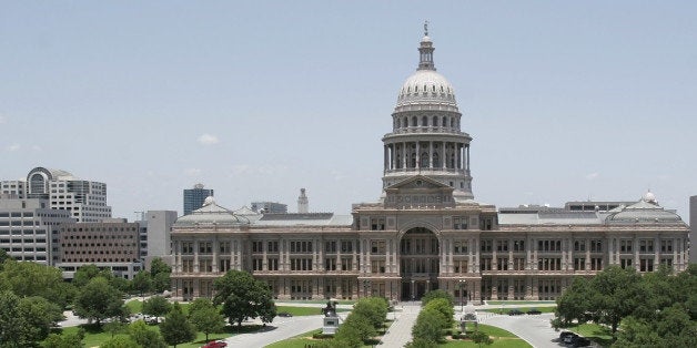 This exterior view of the Capitol with empty parking spaces reserved for lawmakers is shown Friday, June 17, 2005, in Austin,