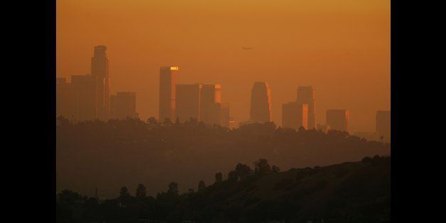 LOS ANGELES, CA - NOVEMBER 17: The downtown skyline is enveloped in smog shortly before sunset on November 17, 2006 in Los Angeles, California. Earlier this month, the South Coast Air Quality Management District, southern California?s anti-smog agency, approved a $36 million program to reduce pollution from trucks operating at the twin ports of Los Angeles and Long Beach. An estimated 12,000 diesel trucks travel to and from the ports each day, carrying freight through southern California metropolitan areas where their emissions are believed to increased risks of asthma and other illnesses among local residents and particularly children. (Photo by David McNew/Getty Images)