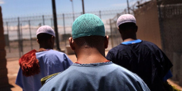 FLORENCE, AZ - JULY 30: Detained Muslim immigrants from Afghanistan (C), Yemen (L), and Somalia (R), walk to a chapel to celebrate Friday prayers at the U.S. Immigration and Customs Enforcement (ICE) detention facility on July 30, 2010 in Florence, Arizona. Most immigrants at the center are awaiting deportation or removal and return to their home countries, while some are interned at the facility while their immigration cases are being reviewed. Arizona holds almost 3,000 immigrants at the detention facilities in Florence and nearby Eloy. The state, which deports and returns more illegal immigrants than any other state, is currently appealing a judge's ruling suspending controversial provisions of Arizona's immigration enforcement law SB 1070. (Photo by John Moore/Getty Images)