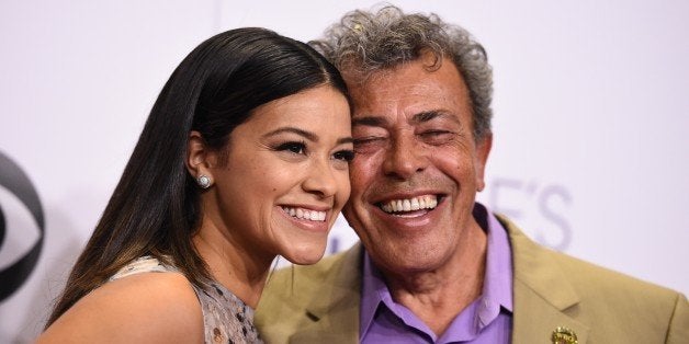 Gina Rodriguez, and Genaro Rodriguez pose in the press room at the People's Choice Awards at the Nokia Theatre on Wednesday,