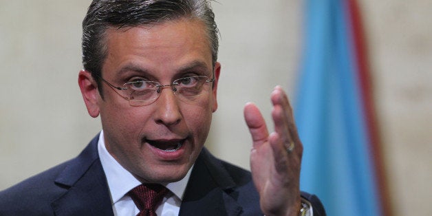 FILE- In this April 30, 2015, file photo, Puerto Rico Gov. Alejandro Garcia Padilla delivers his budget address for the next fiscal year at the Capitol building in San Juan. Puerto Rico's governor believes the U.S. territory's $72 billion public debt is unpayable, his spokesman confirmed late Sunday, June 28, 2015, adding another blow to the international financial system already struggling with a possible default by Greece. (AP Photo/Ricardo Arduengo, File)