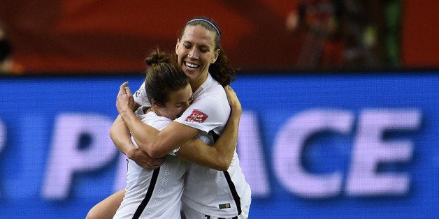 MONTREAL, QC - JUNE 30: Kelley O'Hara and Lauren Holiday of the United States celebrate after the FIFA Women's World Cup 2015 Semi-Final Match at Olympic Stadium on June 30, 2015 in Montreal, Canada. (Photo by Dennis Grombkowski/Bongarts/Getty Images)