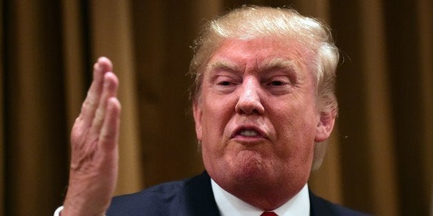 Donald Trump gestures while speaking surrounded by people whose families were victims of illegal immigrants on July 10, 2015 while meeting with the press at the Beverly Wilshire Hotel in Beverly Hills, California, where some shared their stories of the loss of a loved one. The US business magnate Trump, who is running for president in the 2016 presidential elections, angered members of the Latino community with recent comments but says he will win the Latino vote. AFP PHOTO / FREDERIC J. BROWN (Photo credit should read FREDERIC J. BROWN/AFP/Getty Images)