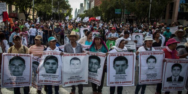 MEXICO CITY, MEXICO - JULY 26: Demonstrators and relatives of the 43 missing students of Ayotzinapa college march during a protest rally ten months after the 43 students disappearance on July 26, 2015 in Mexico City, Mexico. (Photo by Miguel Tovar/LatinContent/Getty Images)