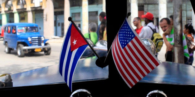 Miniature flags representing Cuba and the U.S. are displayed on the dash of an American classic car in Havana, Cuba, Friday,