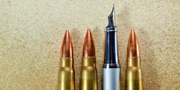 Pen and three bullets arranged verticaly on vintage background. Symbolize the confrontation between the power of the written word and the power of weapons and politics.