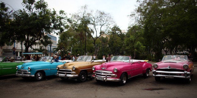 HAVANA, CUBA - SEPTEMBER 16: Vintage American cars being used as tourist taxis are parked alongside each other as drivers wait for customers on September 16, 2015 in Havana, Cuba. Pope Francis is due to make a three day visit to Cuba from September 19 where he will meet President Raul Castro and hold Mass in Revolution Square before travelling to Holguin, Santiago de Cuba, El Cobre and onwards to the United States. (Photo by Carl Court/Getty Images)