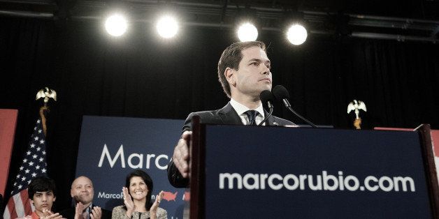 Senator Marco Rubio, a Republican from Florida and 2016 presidential candidate, right, pauses as he speaks during a South Carolina primary night rally in Columbia, South Carolina, U.S., on Saturday, Feb. 20, 2016. Donald Trump, the brash New York billionaire who has upended all the rules of modern campaigning, won Saturday's South Carolina primary in a decisive fashion that shrinks the prospects of his Republican presidential rivals to stop his march to the nomination. Photographer: T.J. Kirkpatrick/Bloomberg via Getty Images 