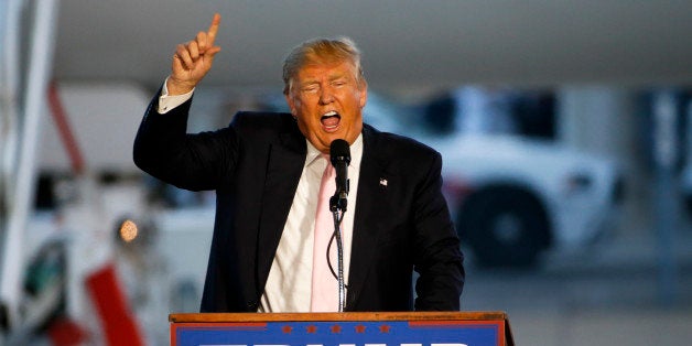 Republican presidential candidate, Donald Trump holds a plane-side rally in a hanger at Youngstown-Warren Regional Airport in Vienna, Ohio, Monday, March 14, 2016. (AP Photo/Gene J. Puskar)