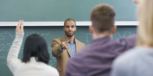 Shot of a young male teacher giving a lesson to his students on the lecture hall