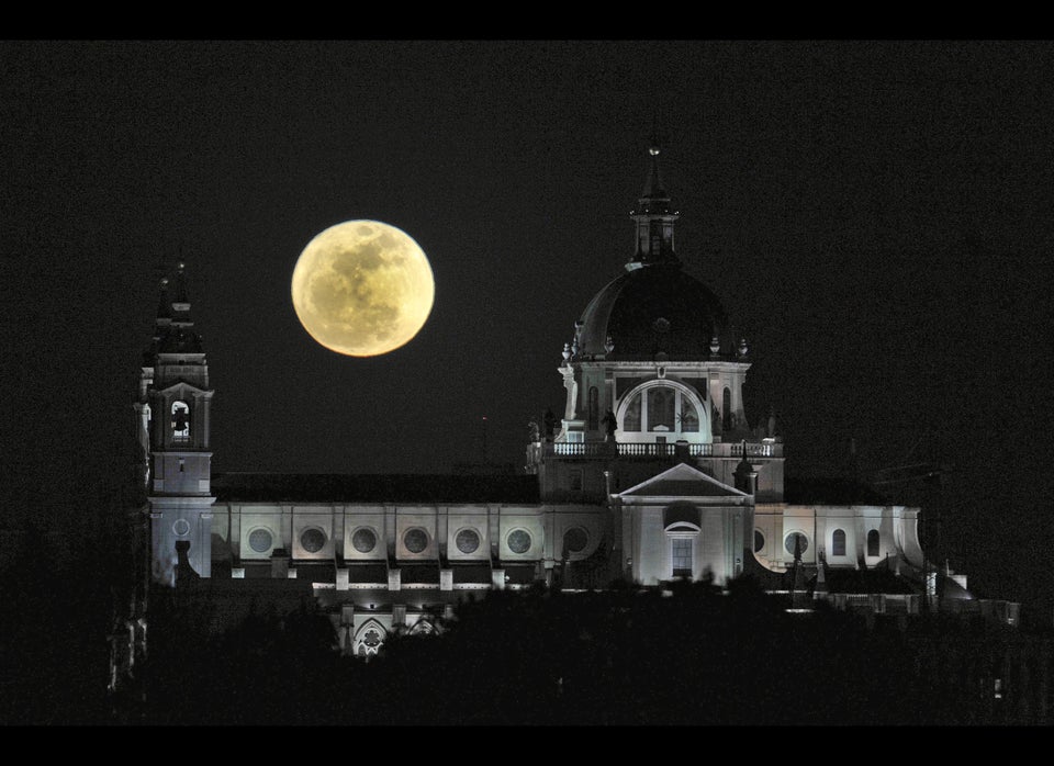 A perigee moon rises above the Almudena