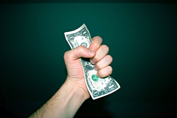 Stingy hand grabbing a dollar