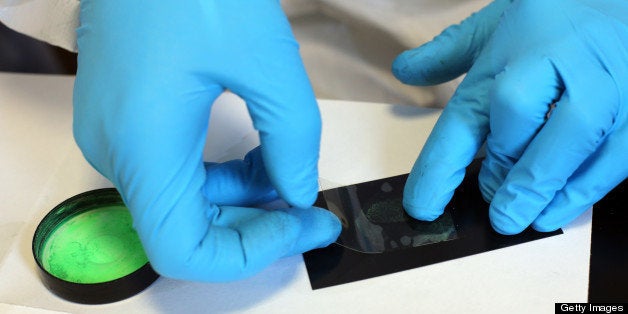 A forensic expert picks up clues during a mock exercise aimed at presenting the work of this kind of police unit, on January 25, 2013 at Poissy's police headquarters. AFP PHOTO THOMAS SAMSON (Photo credit should read THOMAS SAMSON/AFP/Getty Images)