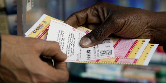 A person purchase Powerball lottery tickets from a newsstand Wednesday, Jan. 6, 2016, in Philadelphia. Players will have a chance Wednesday night at the biggest lottery prize in nearly a year. (AP Photo/Matt Rourke)