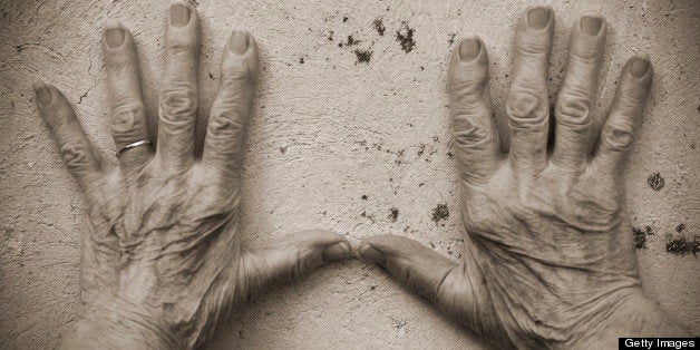 Senior Woman Hands on the wall (sepia toned)