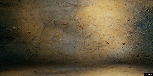 Background. Grunge wall in dark abandoned room.