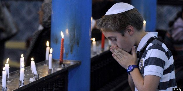 A Jewish boy prays in the Ghriba synagogue on the Tunisian resort island of Djerba at the start of a three-day pilgrimage on April 26, 2013. Pilgrims arrived at Tunisia's Ghriba synagogue, the oldest in Africa, expressing hope that this year would mark a turning point for the ritual despite a rise in Islamist unrest since the 2011 revolution. AFP PHOTO / FETHI BELAID (Photo credit should read FETHI BELAID/AFP/Getty Images)