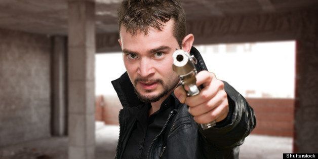 portrait of a man holding gun ...