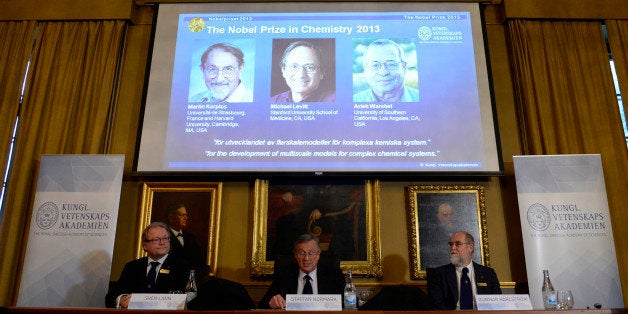 (L-R) Sven Lidin, Staffan Normark and Gunnar Karlstrom sit in front of a screen displaying the portraits of scientists (L-R) Martin Karplus, Michael Levitt and Arieh Warshel during a press conference to announce the laureates of the 2013 Nobel Prize in Chemistry on October 9, 2013 at the Nobel Assembly at the Royal Swedish Academy of Sciences in Stockholm. US-Austrian Martin Karplus, US-British Michael Levitt and US-Israeli Arieh Warshel won Nobel Chemistry Prize for the development of multiscale models for complex chemical systems. AFP PHOTO / JONATHAN NACKSTRAND (Photo credit should read JONATHAN NACKSTRAND/AFP/Getty Images)