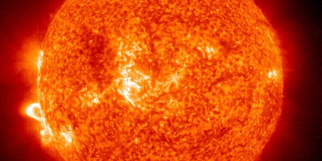 IN SPACE - NOVEMBER 18: In this handout photo provided by NASA, a Solar and Heliospheric Observatory image shows Region 486 that unleashed a record flare last week (lower left) November 18, 2003 on the sun. The spot itself cannot yet be seen but large, hot, gas-filled loops above this region are visible. These post-flare loops are still active. (Photo by NASA via Getty Images) 