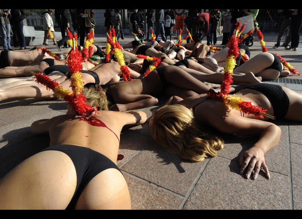 PETA animal rights activists demonstrate naked and speared with banderillas against the EU cash support for bullfights in fro