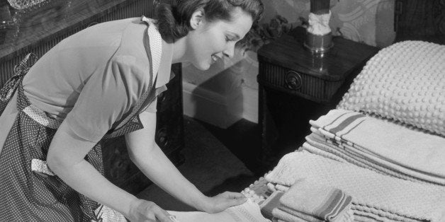 UNITED STATES - CIRCA 1950s: Housewife sorting ironed linens & towels. (Photo by George Marks/Retrofile/Getty Images)