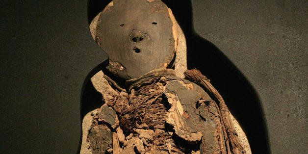 A Chinchorro mummy of a child - dated between 5000 B.C. and 3000 B.C. - is on display during the exhibition 'Arica, a thousand-year-old culture', on August 27, 2008, in the cultural centre of the La Moneda presidential palace in Santiago. In the Chinchorro culture, everyone who died was mummified, and it was not a symbol of high social status. AFP PHOTO/Claudio Santana (Photo credit should read CLAUDIO SANTANA/AFP/Getty Images)