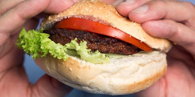 A beef burger created by stem cells harvested from a living cow is held for a photograph by Mark Post, a Dutch scientist, following a Bloomberg Television interview in London, U.K., on Tuesday, Aug. 6, 2013. The 5-ounce burger, which cost more than 250,000 euros ($332,000) to produce, was developed by Post of Maastricht University with funding from Google co-founder Sergey Brin. Photographer: Simon Dawson/Bloomberg via Getty Images