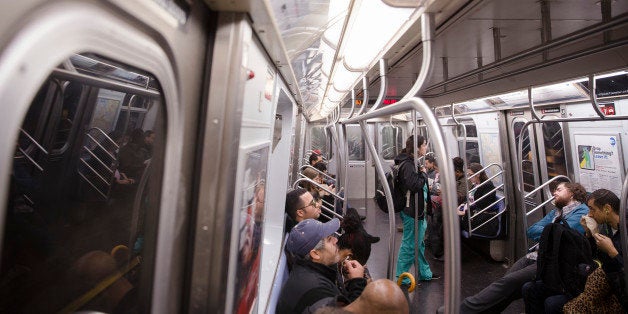 Commuters ride inside an L train subway car, Friday, Oct. 24, 2014, in New York. Craig Spencer, a Doctors Without Borders phy