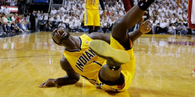 Indiana Pacers guard Lance Stephenson (1) yells after he fell hard following a foul from Miami Heat center Chris Bosh during the first half of Game 3 in the NBA basketball Eastern Conference finals playoff series, Saturday, May 24, 2014, in Miami. (AP Photo/Lynne Sladky)