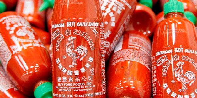 FILE - In this Tuesday, Oct 29, 2013, file photo, Sriracha chili sauce bottles are produced at the Huy Fong Foods factory in Irwindale, Calif. A judge has given a dose of cold water to the hot sauce Sriracha, ruling Tuesday, Nov. 26, 2013, that the factory that manufactures the trendy condiment must partially shut down after neighbors complained of the spicy smells it was producing. (AP Photo/Nick Ut, File)