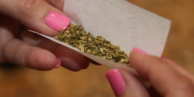 BETHPAGE, NY - AUGUST 30: A woman rolls a marijuana cigarette as photographed on August 30, 2014 in Bethpage, New York. (Photo by Bruce Bennett/Getty Images)