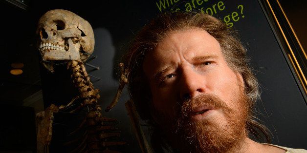 The skeleton of a neolithic man who was buried around 5,500 years ago in a long barrow 1.5 miles from the prehistoric monument of Stonehenge, a world heritage site, is displayed next to a reconstruction of the man's face at the new Stonehenge visitors centre, near Amesbury in south west England on December 11, 2013. Forensic evidence tells us that he is 25 40 years old, of slender build, born about 500 years before the circular ditch and banks, the first monument at Stonehenge, was built. Stonehenge's new visitor centre opens on December 18 in time for the winter solstice, hoping to provide an improved experience for the million tourists that flock annually to Britain's most famous prehistoric monument. AFP PHOTO / LEON NEAL (Photo credit should read LEON NEAL/AFP/Getty Images)