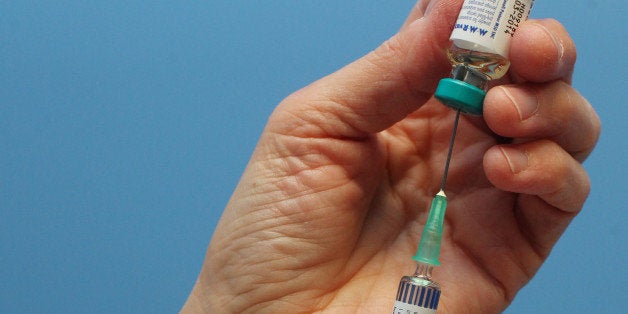 A nurse uses a syringe to prepare an injection of the combined Measles Mumps and Rubella (MMR) vaccination at an MMR drop-in clinic at Neath Port Talbot Hospital near Swansea in south Wales on April 20, 2013. Public health officials said on April 19 they were investigating the first suspected death from measles in Britain in five years, after an outbreak blamed on a campaign against vaccinations. More than 800 people have contracted the highly contagious disease in Wales in the past six months, centred around the southern city of Swansea. Marion Lyons, director of health protection for Wales, said it had now been confirmed that a 25-year-old man from Swansea who died on April 18 had measles, a full postmortem will be conducted to determine cause of death. AFP PHOTO / GEOFF CADDICK (Photo credit should read GEOFF CADDICK/AFP/Getty Images)