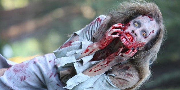 Zombie woman scratches her face, wide shot