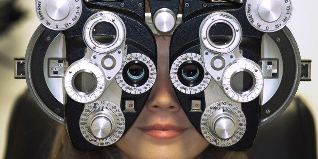 Woman's Face Behind Eye Exam Machine