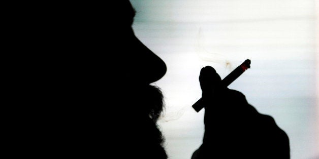 In this April 14, 2011 photo, Joe Bey enjoys a cigarette in Conner's Pub in Indianapolis. Indianaâs top anti-tobacco agency has reached its 10th birthday with mixed results to show for its efforts, with more smokers quitting the habit and communities and employers going smoke-free, but the state retaining its distinction as a tobacco industry favorite. (AP Photo/Michael Conroy)