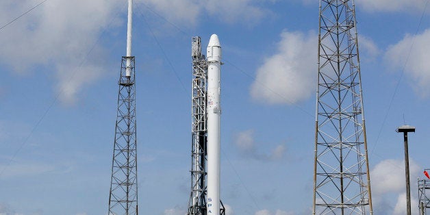 The Falcon 9 SpaceX rocket stands ready for launch at Complex 40 at the Cape Canaveral Air Force Station in Cape Canaveral, Fla., Monday, April 13, 2015. The rocket, scheduled to launch later Monday, is filled with more than 4,300 pounds of supplies and payloads, including critical materials to directly support research at the International Space Station. (AP Photo/John Raoux)