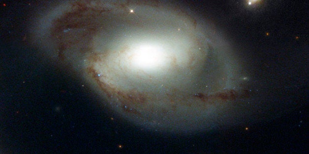 In this NASA Hubble Space Telescope image released Oct. 3, 2002 shows an odd celestial duo, the spiral galaxy NGC 4319 [cente