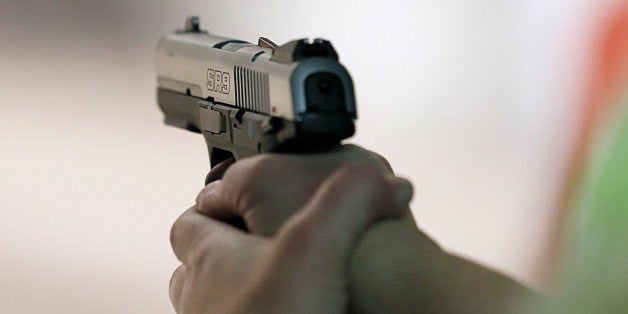 SALT LAKE CITY, UT - JANUARY 15: A women fires a handgun at the 'Get Some Guns & Ammo' shooting range on January 15, 2013 in Salt Lake City, Utah. Lawmakers are calling for tougher gun legislation after recent mass shootings at an Aurora, Colorado movie theater and at Sandy Hook Elementary School in Newtown, Connecticut. (Photo by George Frey/Getty Images)