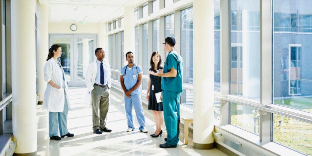 Medical team in discussion in hospital corridor